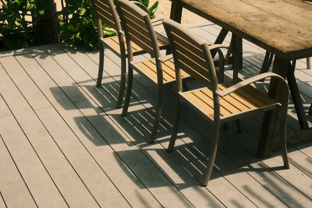 Terrasse Holz oder WPC: drei Stühle und ein Tisch auf einem Holzdeck