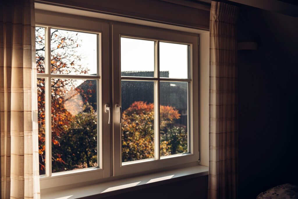 Weißes Holzfenster mit Sprossen nach dem Fenster tauschen